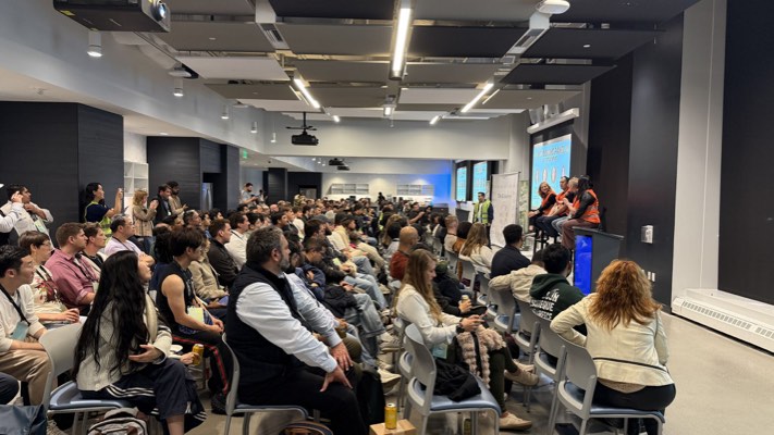 Founder pitching on stage at demo night